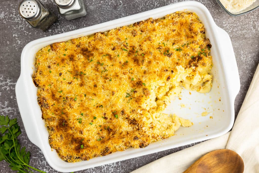 Mac and cheese in a baking dish with a serving taken out of it