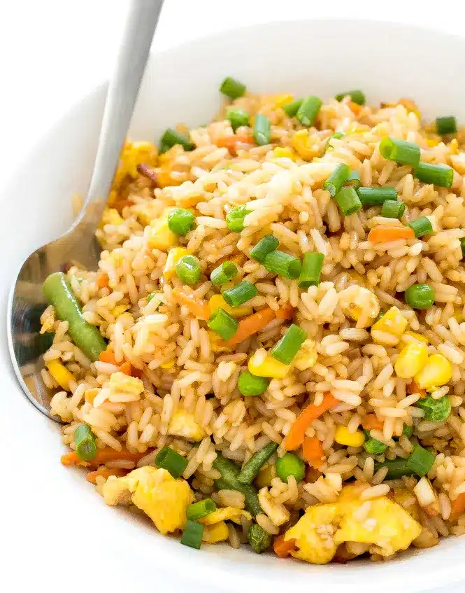 fried rice in a bowl with a spoon