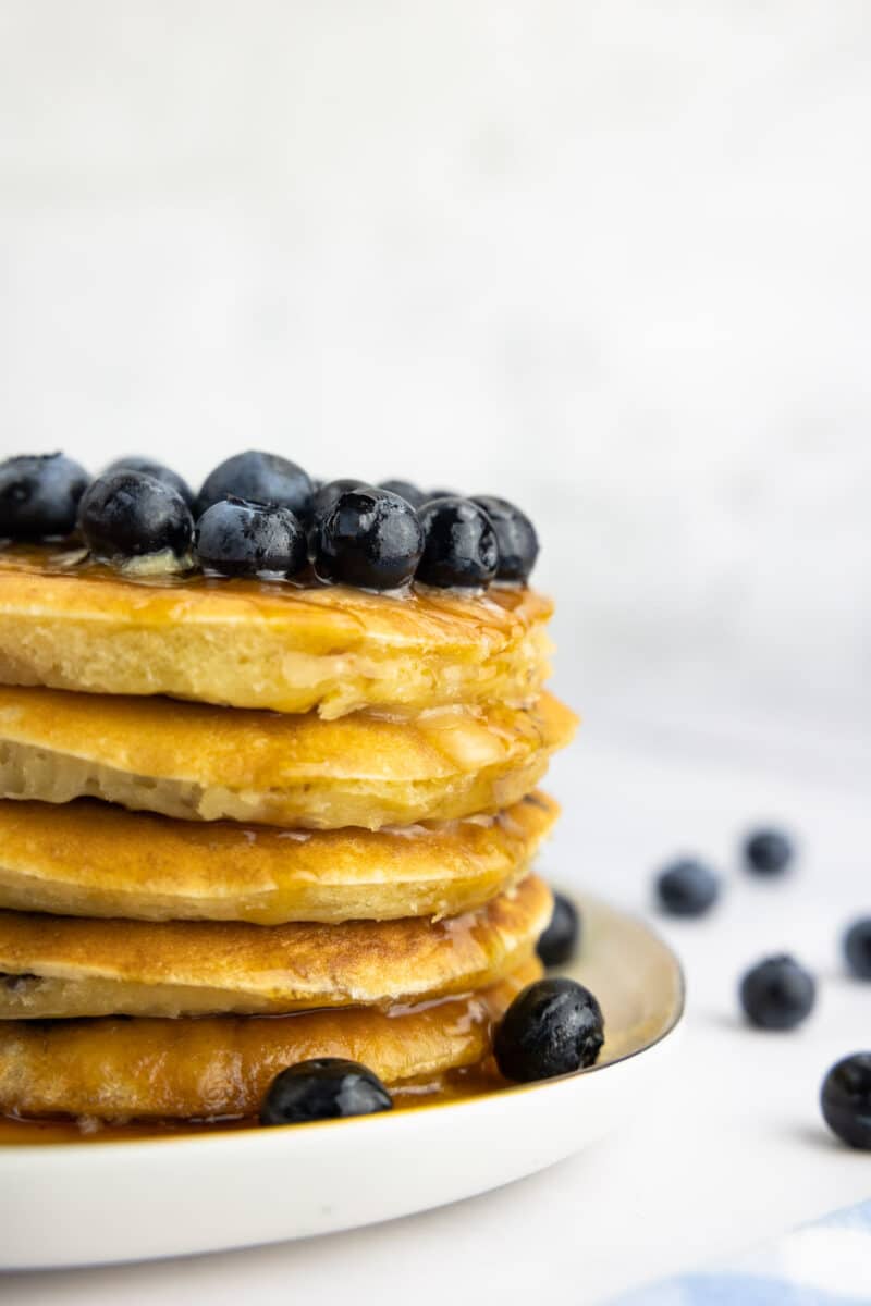 Buttermilk blueberry pancakes with butter, maple syrup and blueberries