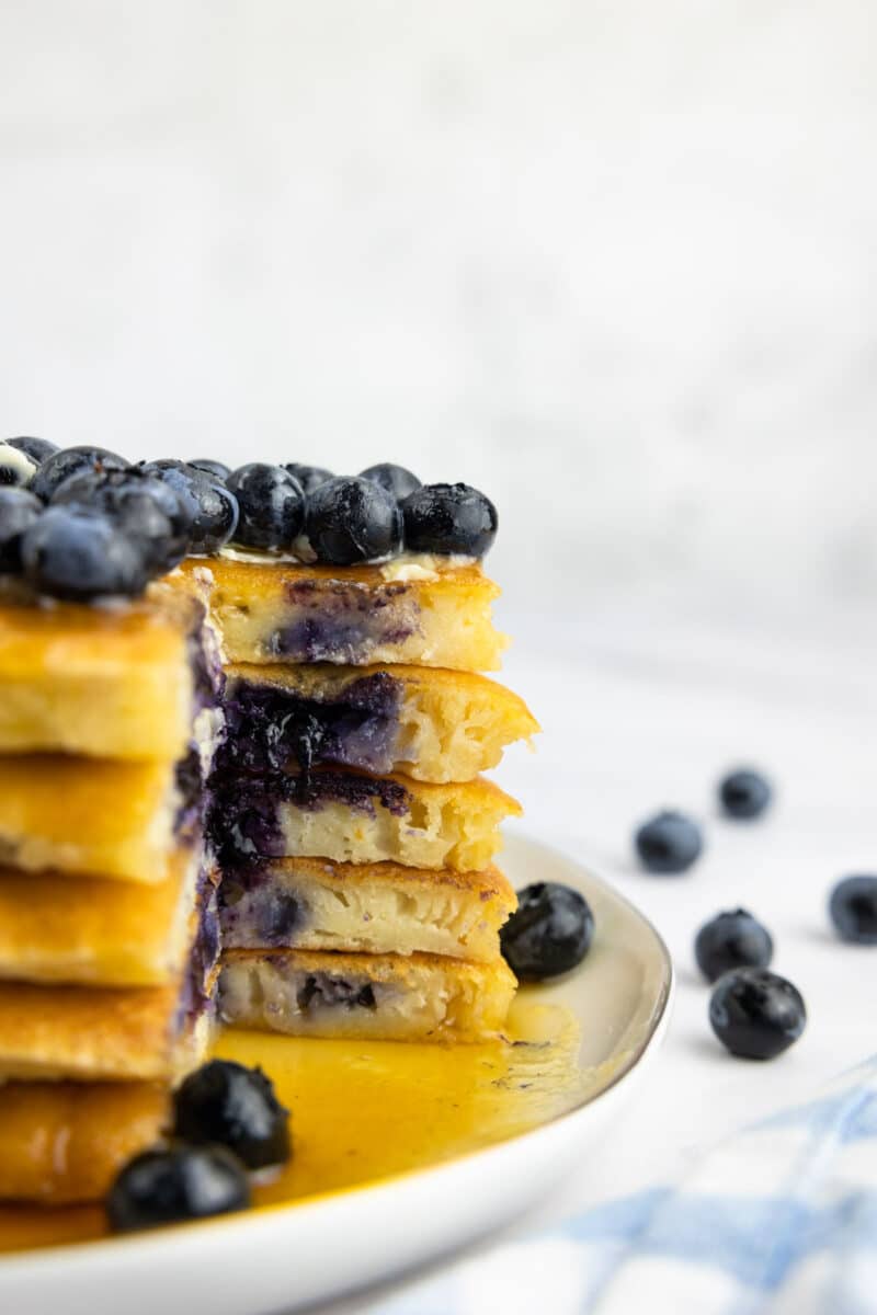 Buttermilk blueberry pancakes with butter, maple syrup and blueberries