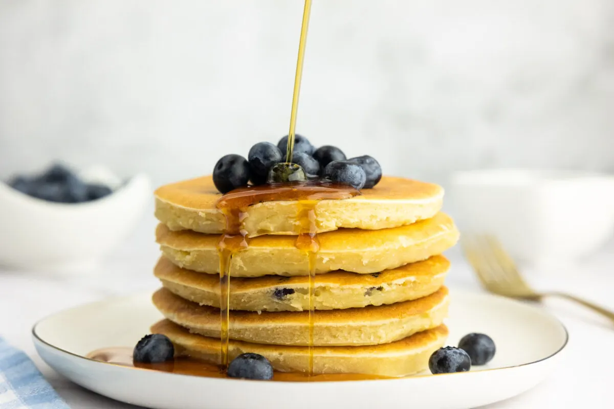 Buttermilk blueberry pancake stack with blueberries and maple syrup