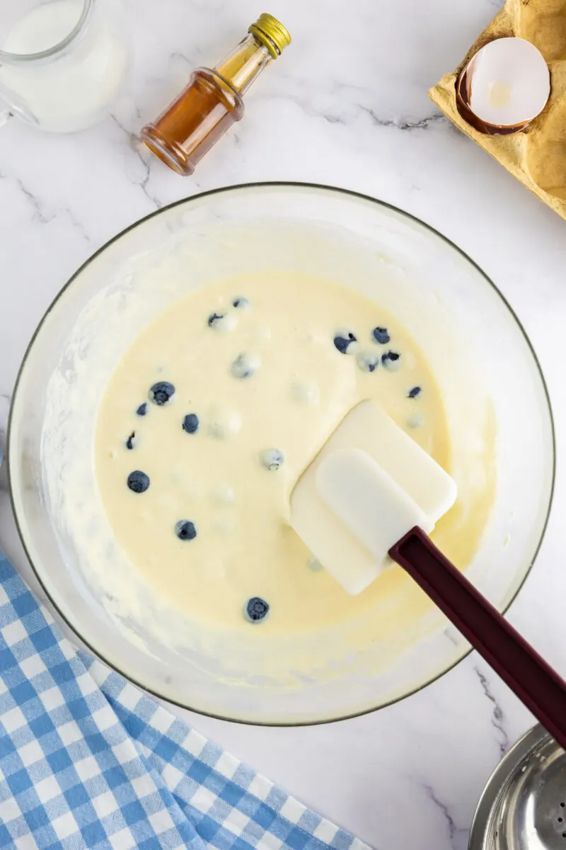 Folding in blueberries to the pancake batter