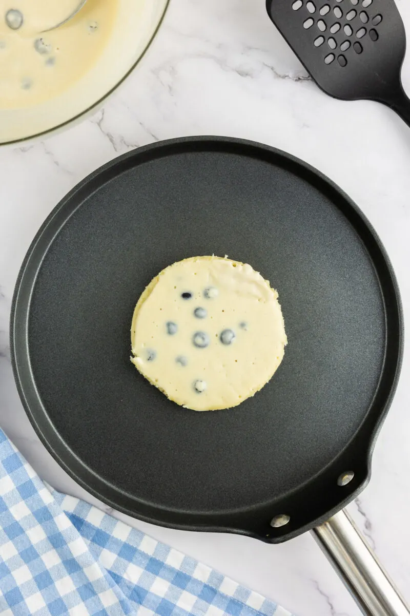 Buttermilk Blueberry Pancake batter on a pan
