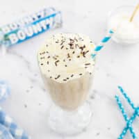 Bounty milkshake in a glass with a straw
