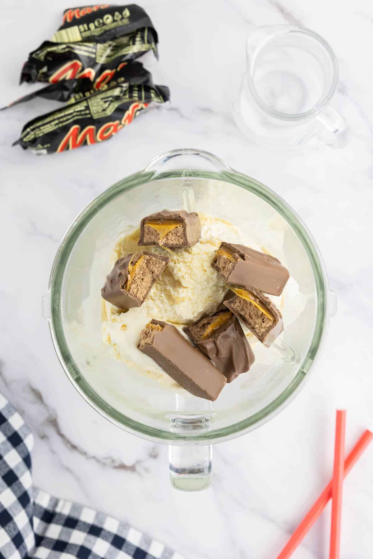 Mars bars added to vanilla ice cream and milk in a blender