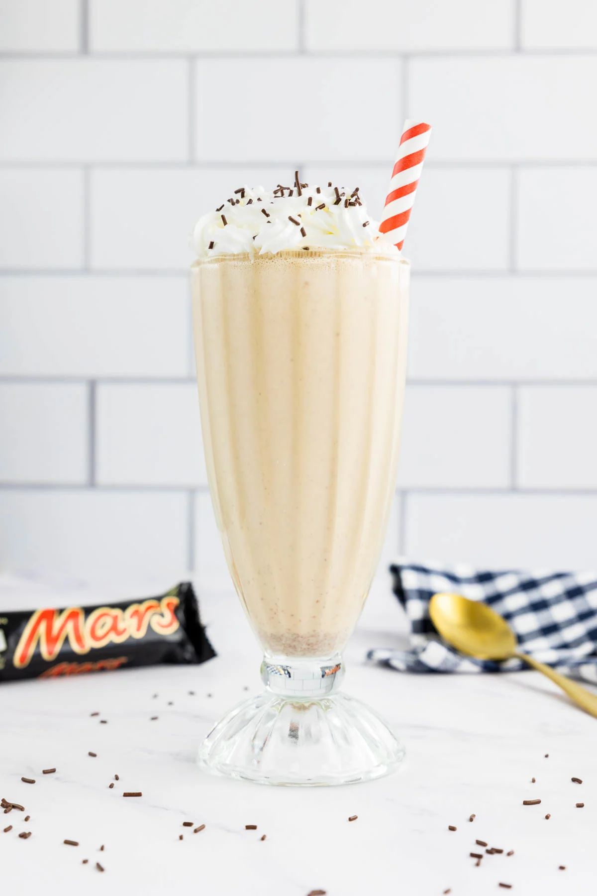Mar milkshake in a glass with whipped cream and sprinkles