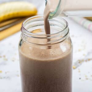 Weight gainer smoothie being poured into a glass