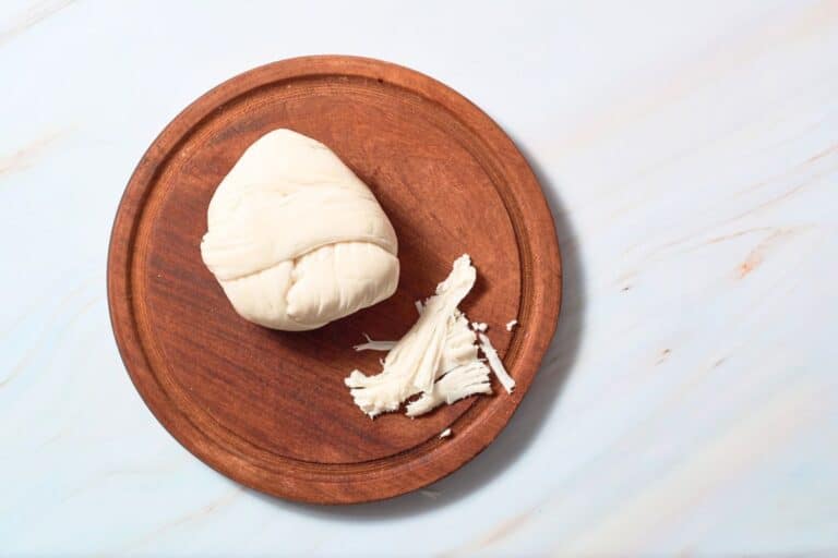 Oaxaca cheese on a wooden board.