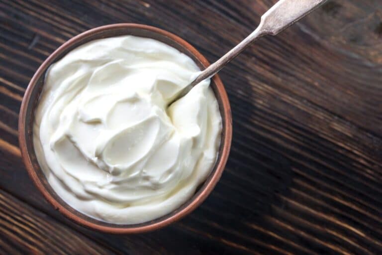 Creme Fraiche in a bowl on a wooden table.