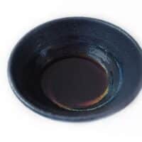 A small amount of liquid smoke in a bowl.
