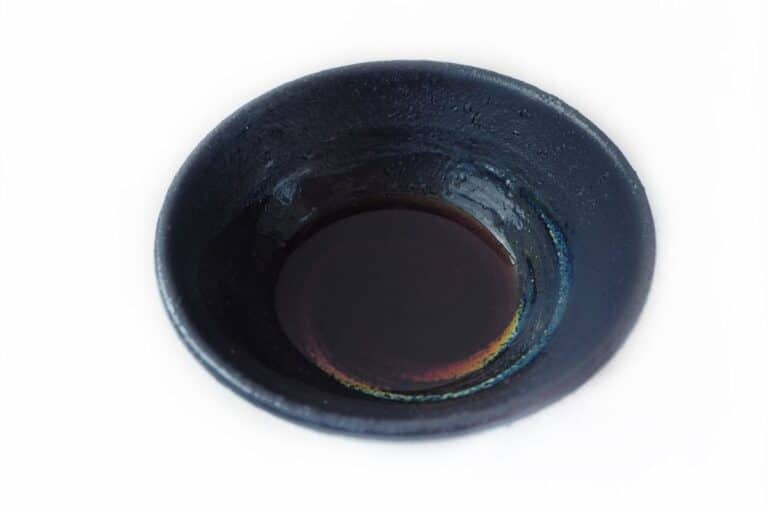 A small amount of liquid smoke in a bowl.