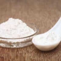 Baking powder in a bowl and spoon.