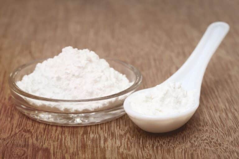 Baking powder in a bowl and spoon.