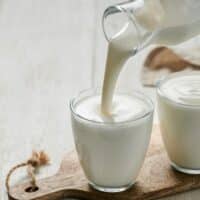 Buttermilk being poured into a glass.