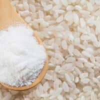 Rice flour in a spoon on top of rice.