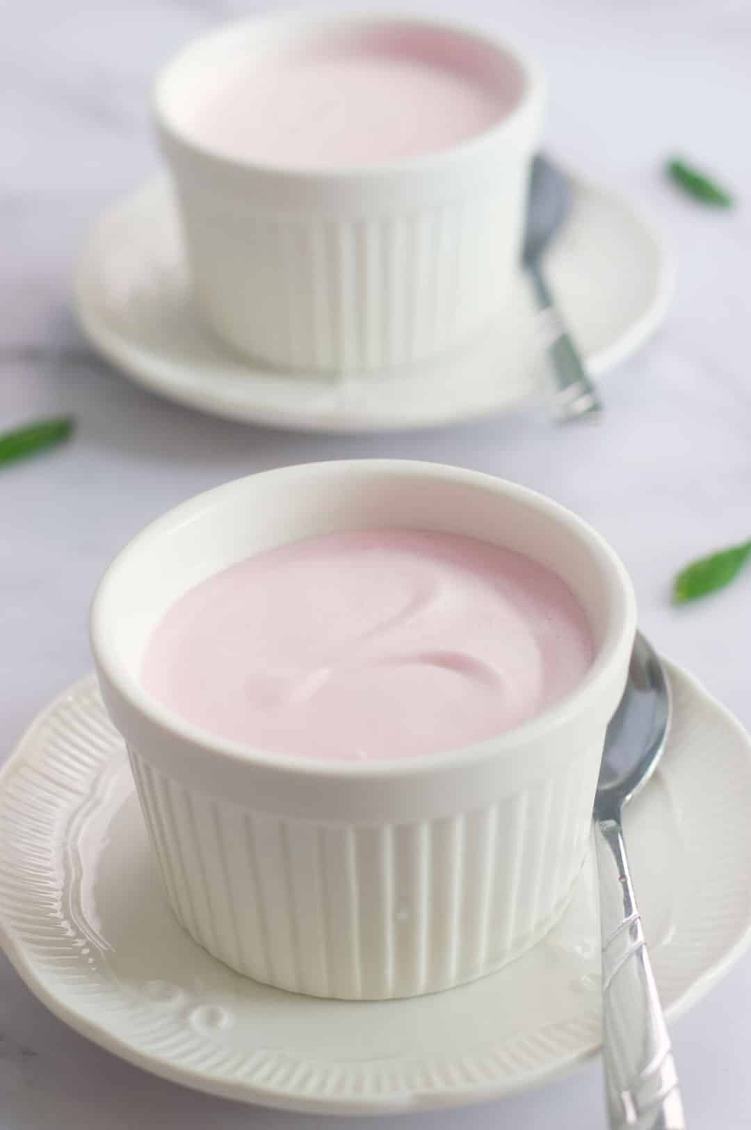 Two strawberry mousse in a white ramekins.