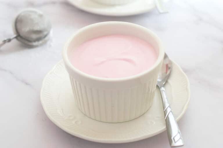 Strawberry mousse made without gelatin in a white ramekin.