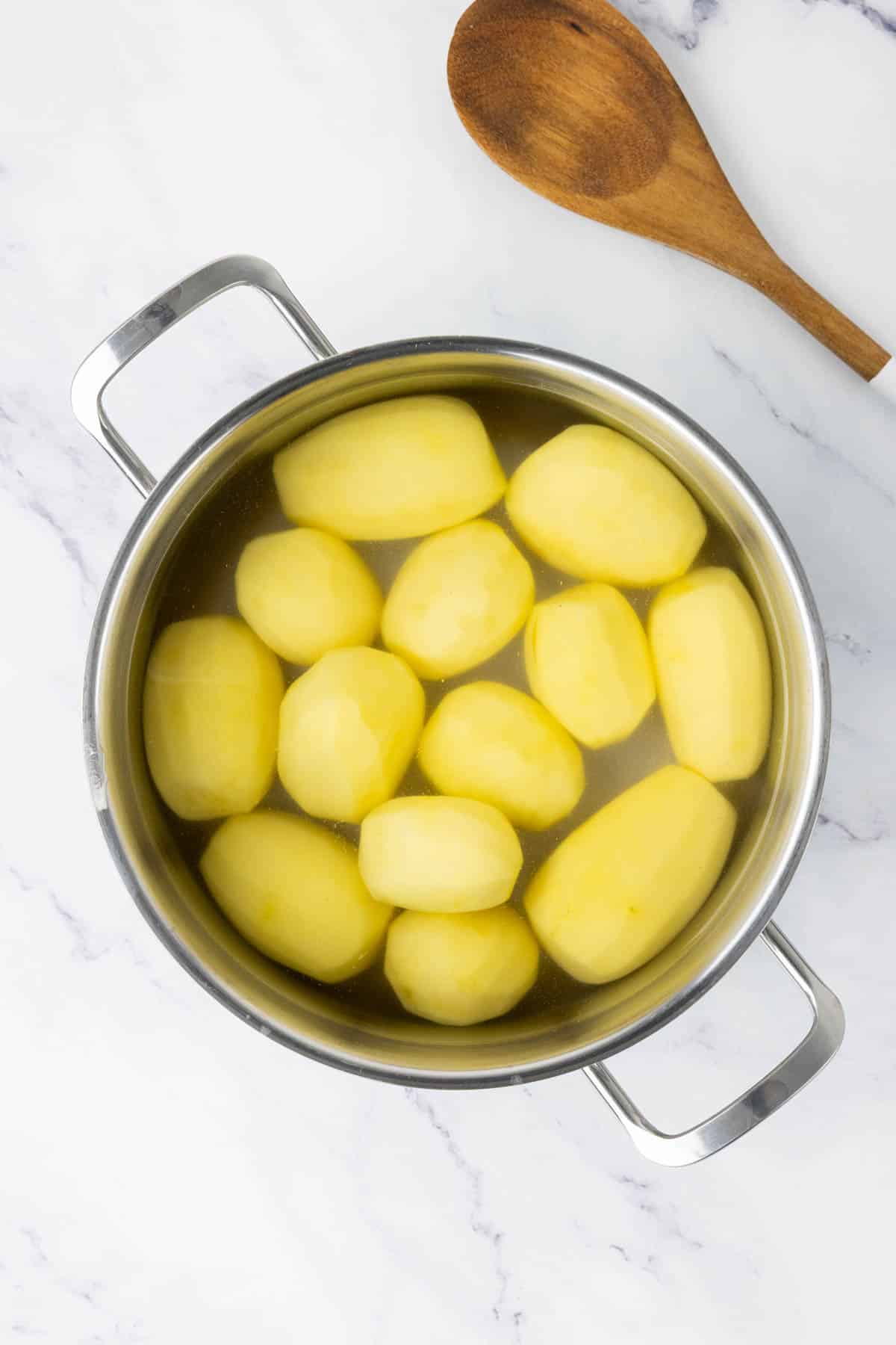 Potatoes in a pot of cold water.