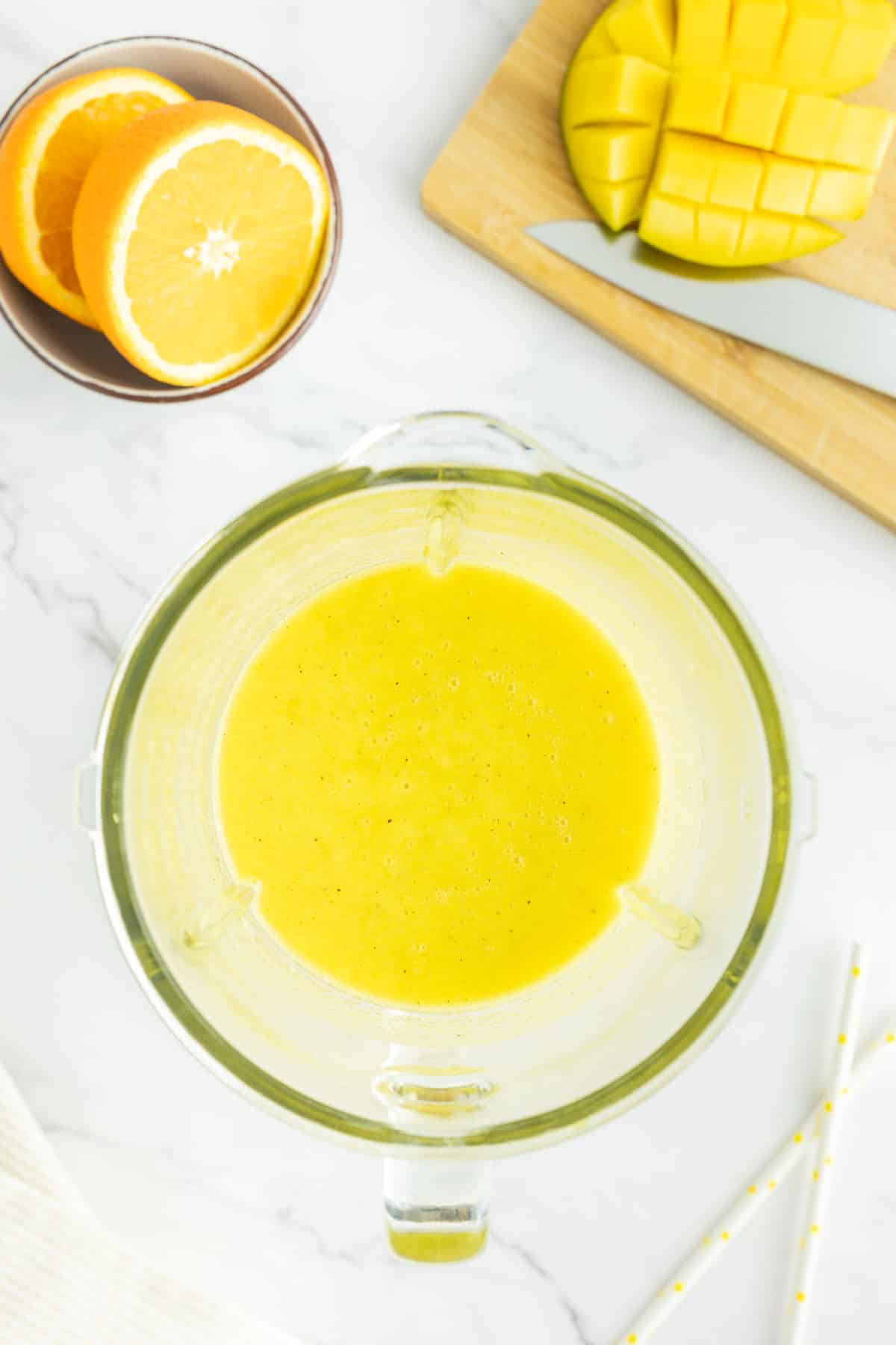 Mango, pineapple smoothie in a blender.